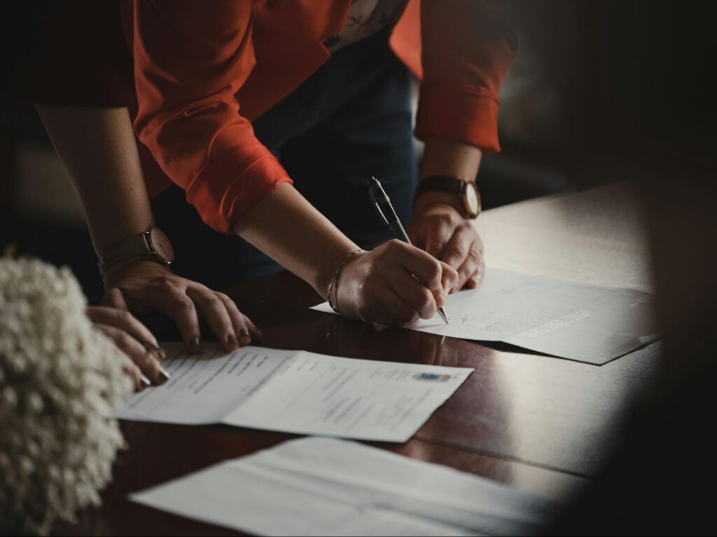 a family signs paper during an application process for a bathroom adaptation grant in Ireland