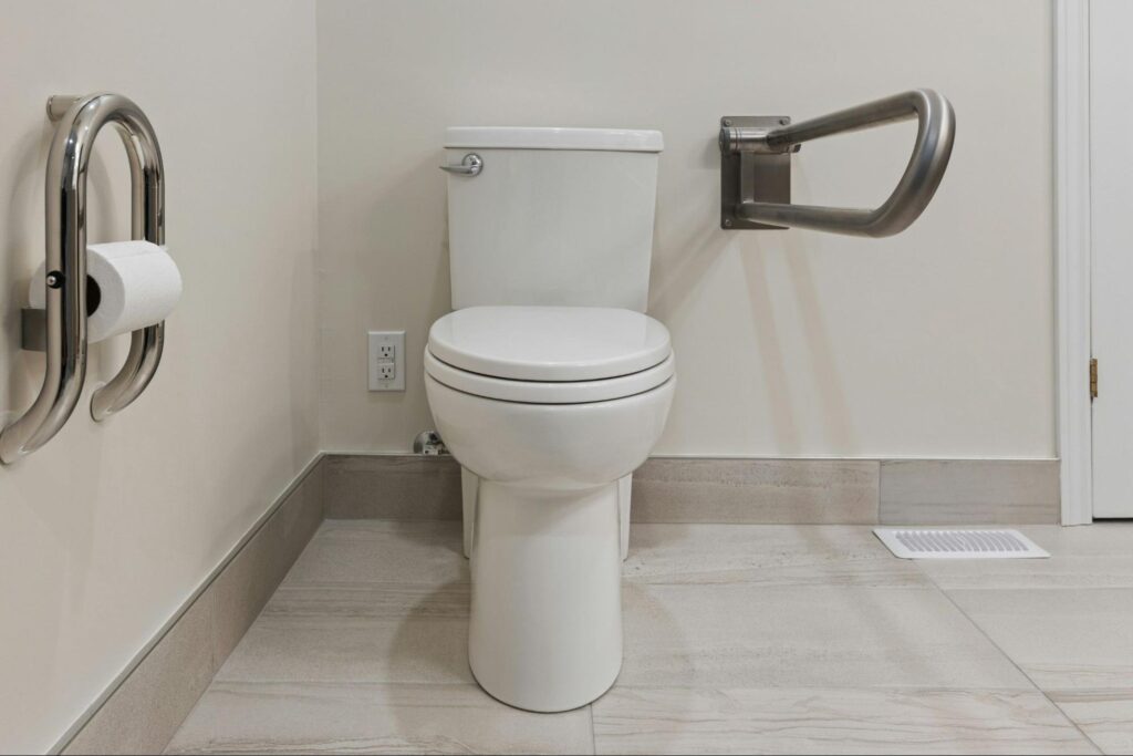 a raised toilet with accessible features suitable for elderly people with mobility problems