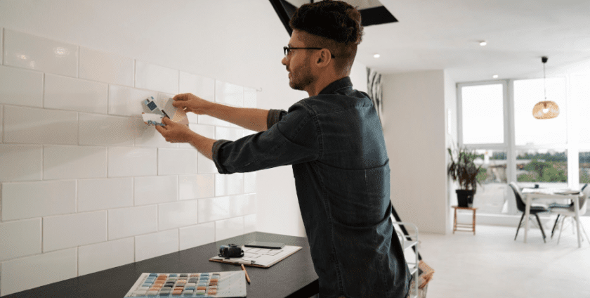 A man with glasses choosing tiles to remodel office space in Ireland