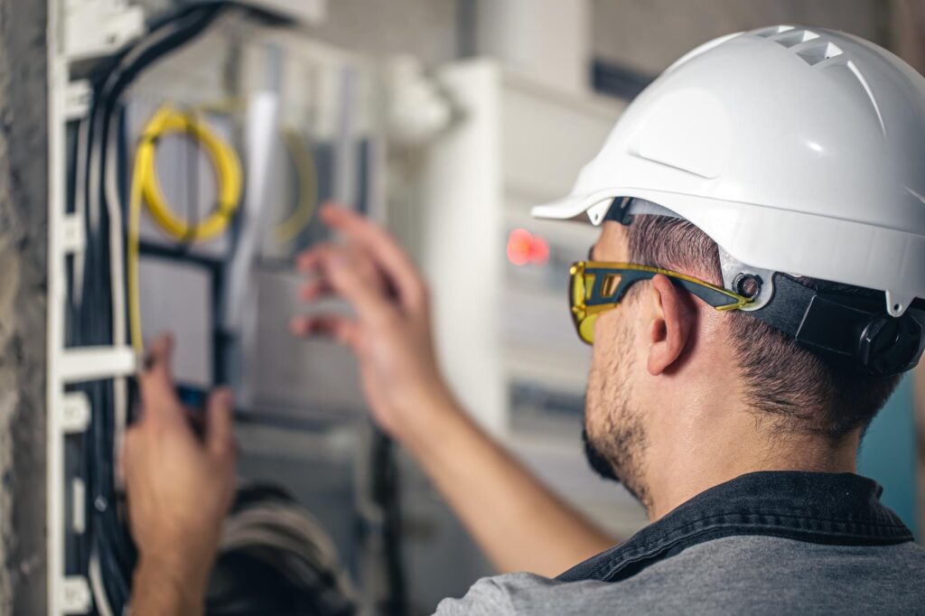 Electrical 2 an electrician works on the electrical panel of a house