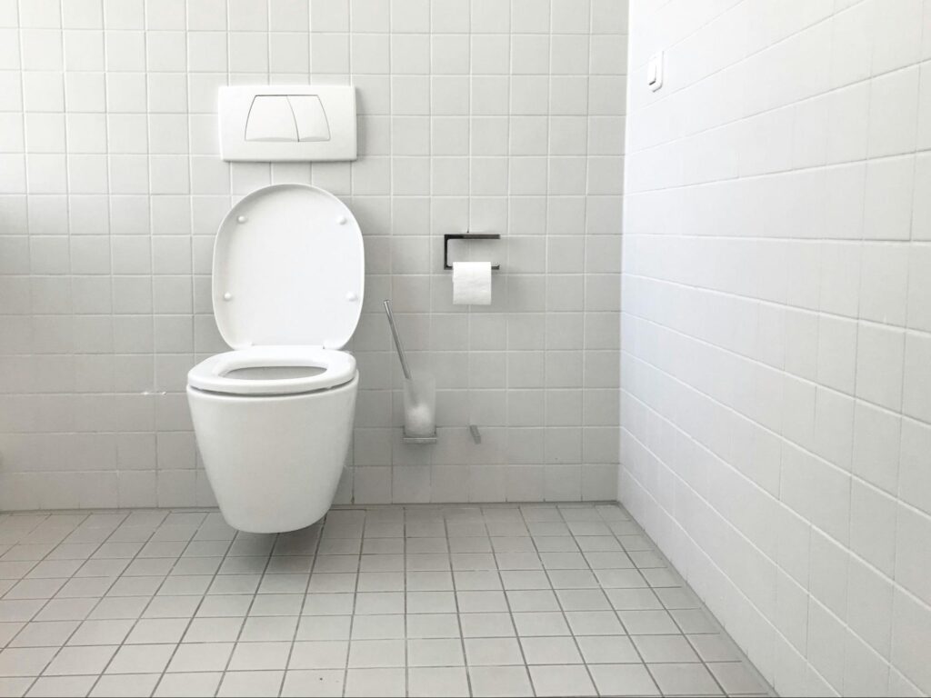 a toilet in a bathroom that needs emergency plumbing service