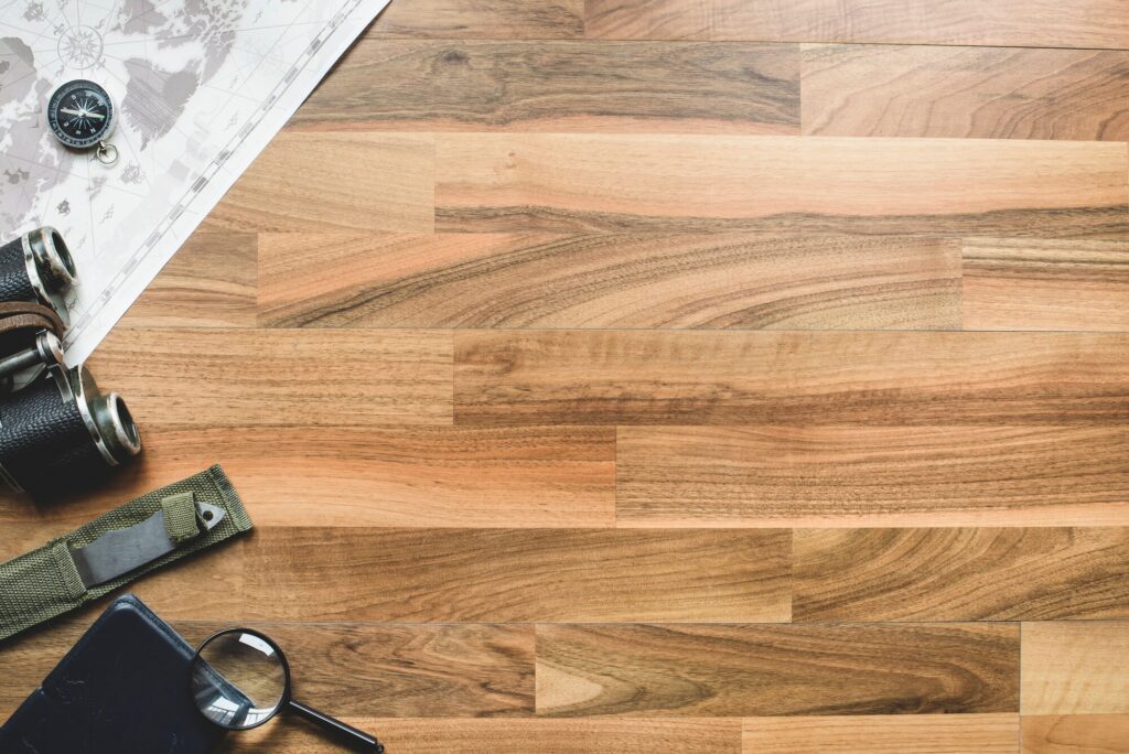Your Complete Guide to Laminate Flooring 3 scouts items placed on a laminate floor that resembles natural wood
