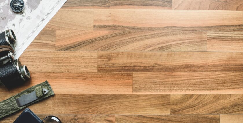 Your Complete Guide to Laminate Flooring 1 scouts items placed on a laminate floor that resembles natural wood