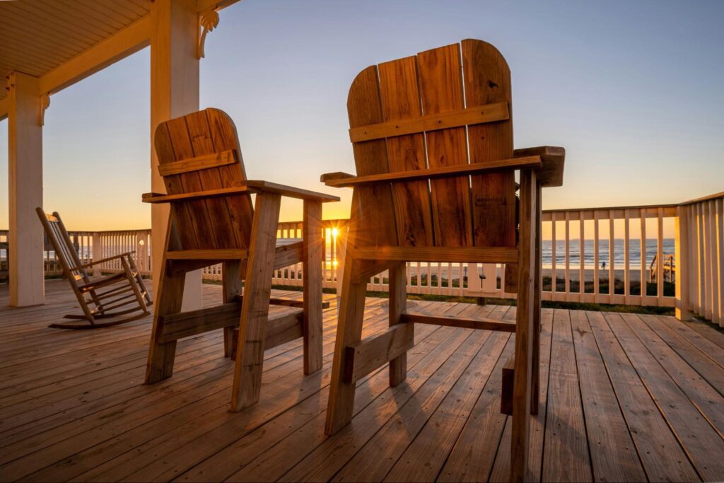 Carpentry 3 wooden flooring and decking with chairs facing the sea