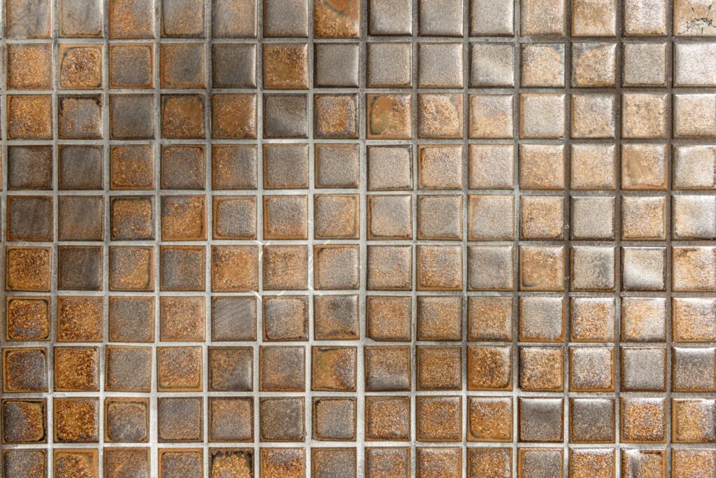 Your Complete Guide to Floor Tiles 7 golden coloured tiles installed on a floor
