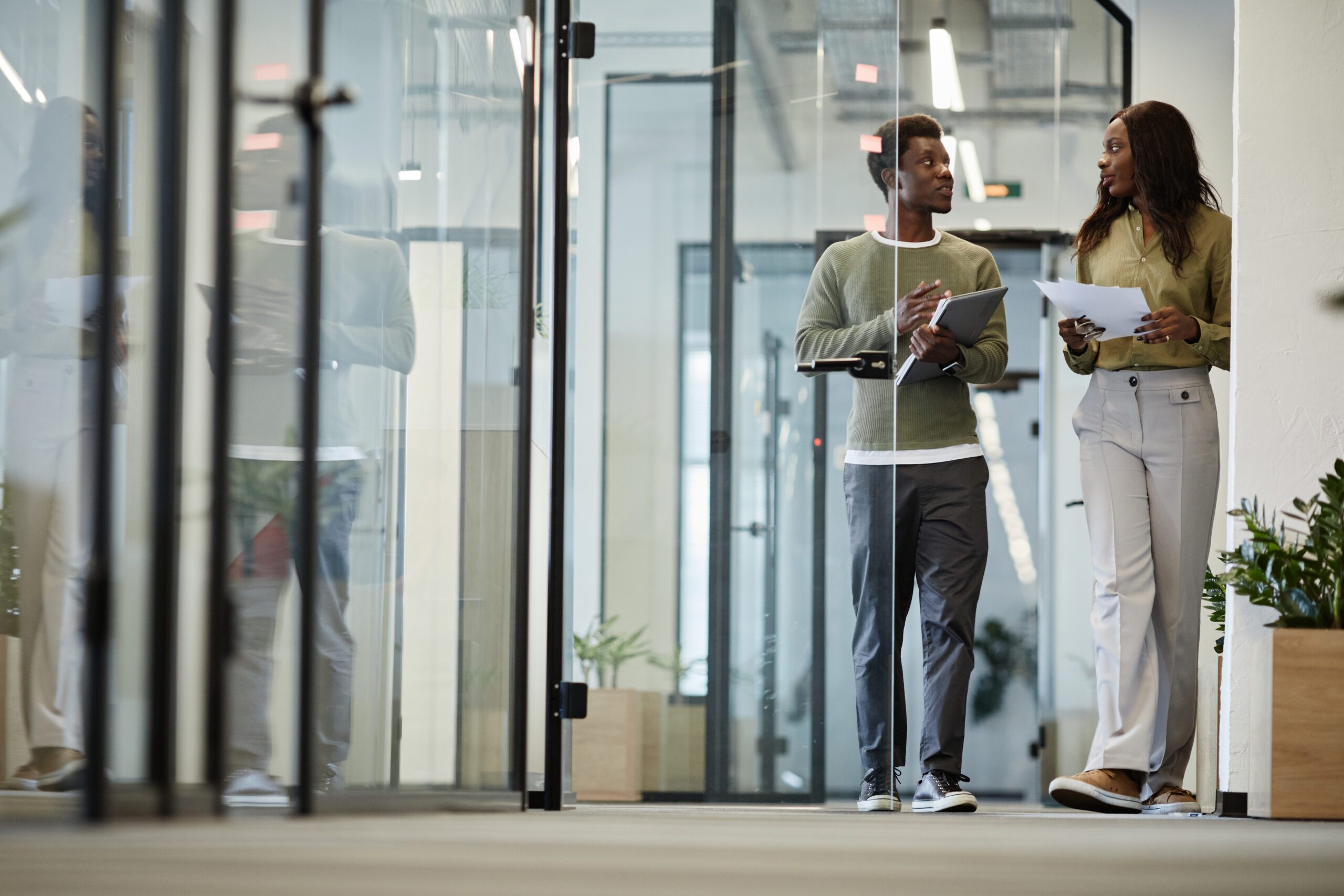 Building Removing Partition Walls 6 Business people walking down office corridor and discussing details of project they are working on