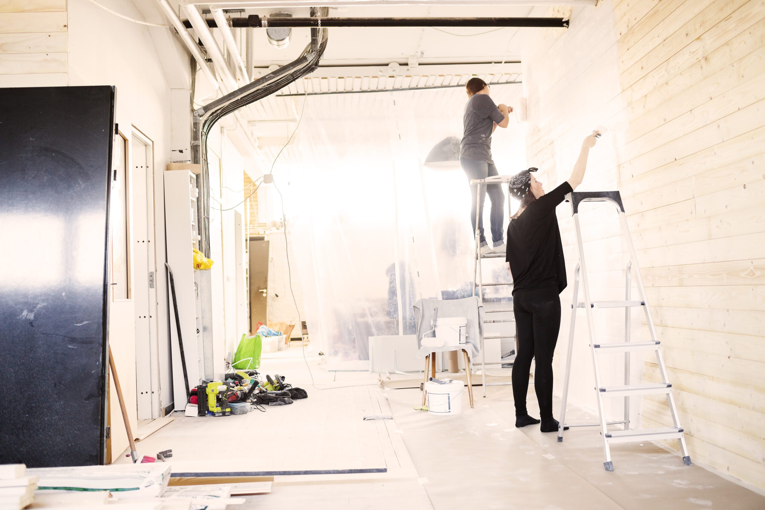 Interior Renovations 2 Women painting wooden wall