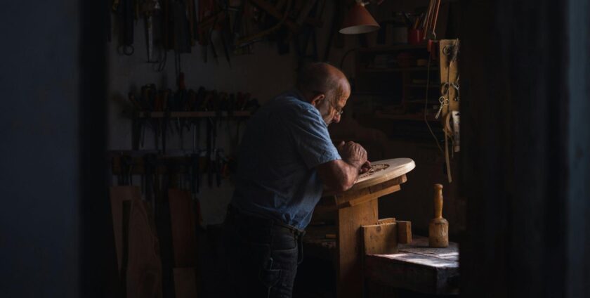 Old man carving wood