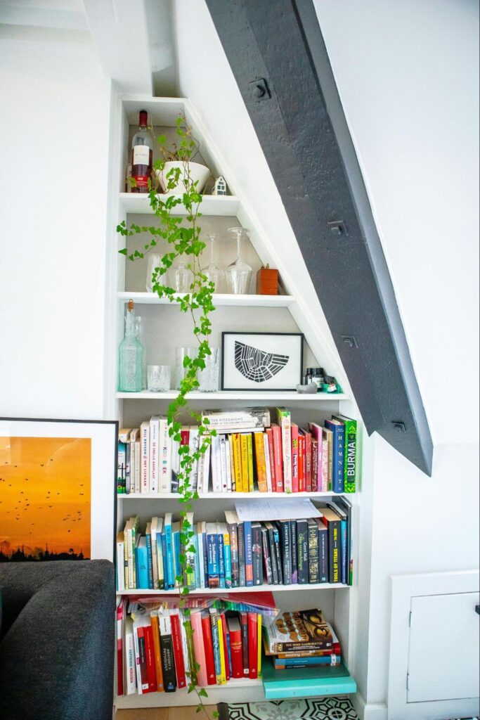 10 Simple and Effective Under Stairs Storage Ideas 4 A small bookshelf with books and accessories
