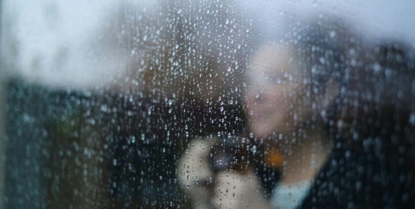 Woman standing behind a window