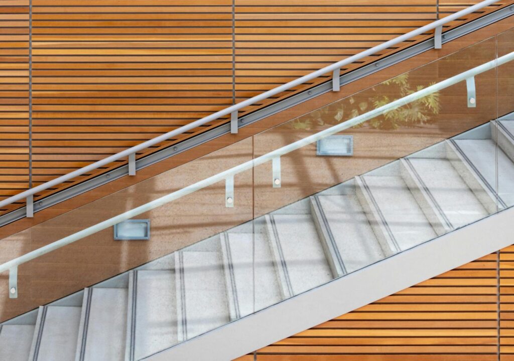 Stair Panelling: Types, Tools and How-to Steps 4 A modern glass staircase with wood panelling