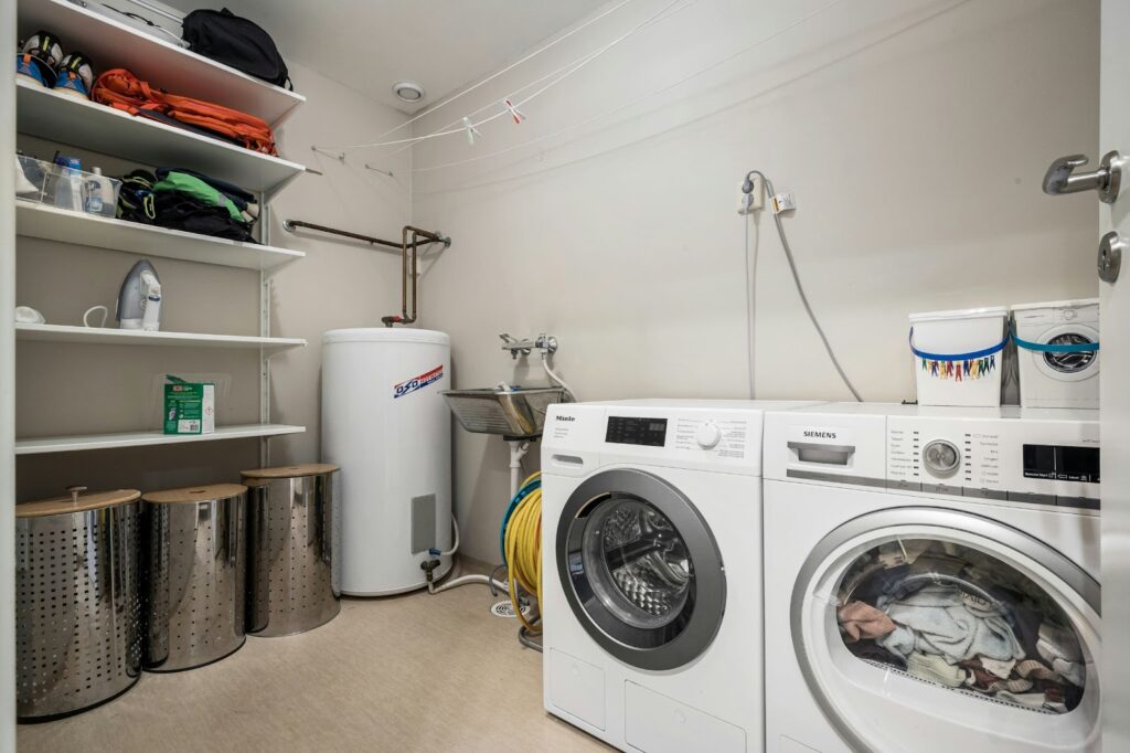 How to Plumb a Washing Machine 5 A utility room with two waching machines and shelving.