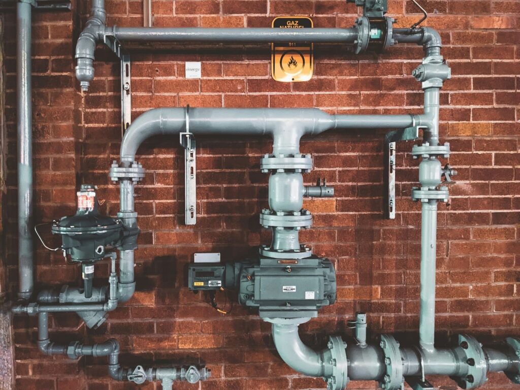 Pipe system on a red brick wall