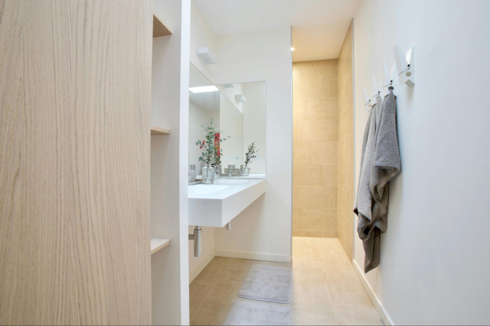 image3 A clean look small bathroom with a large mirror over the sink