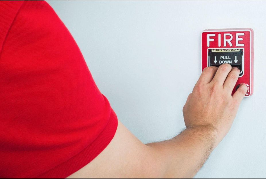 Fire Safety Considerations for Home Renovations in Ireland 2 a man pulling a fire alarm